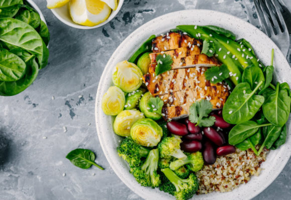 Plate with chicken, vegetables, and grains.