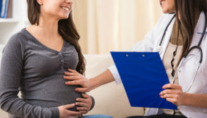 Pregnant woman with female doctor.