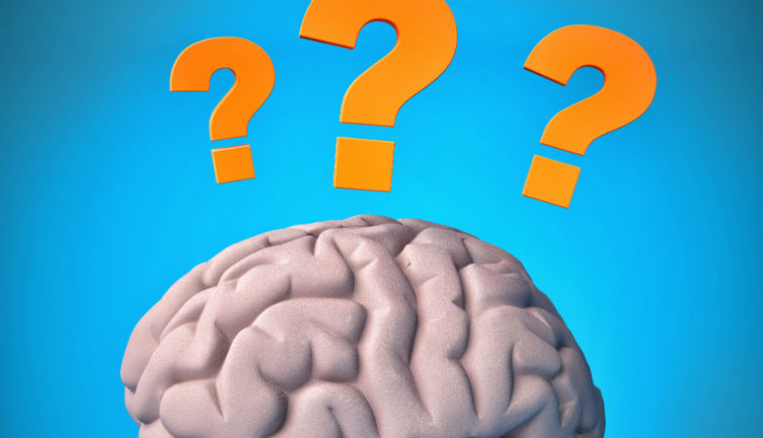 Graphic of brain matter with three question marks above it.