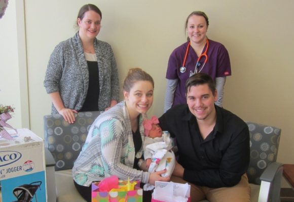 Parents holding a newborn.