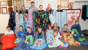 Children holding blankets.
