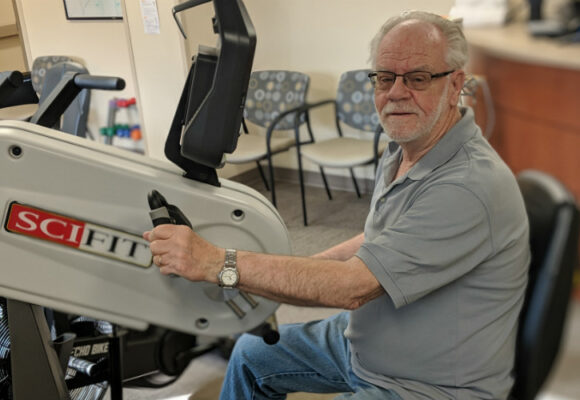 Man using exercise machine.