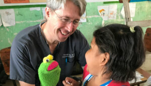 Male doctor with a young female patient.