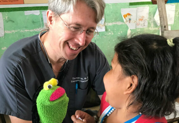 Male doctor with a young female patient.