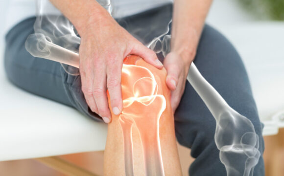 Interior photo. Two hands grasping right knee.