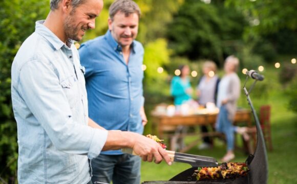 Two_Men_Grilling Two men grilling food outdoors.