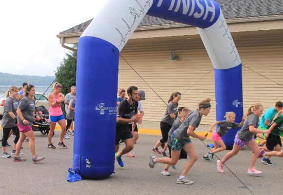 Runners of all ages leaving the start line in a race