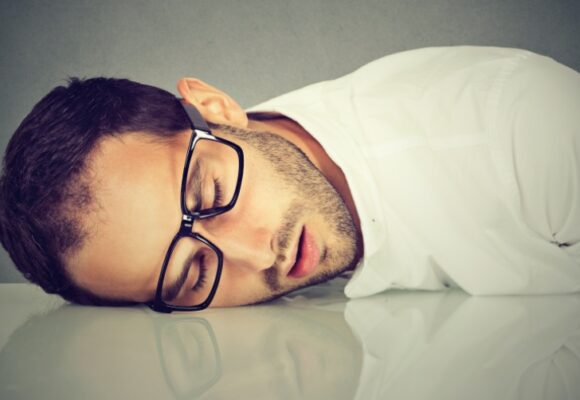 man sleeping on desk