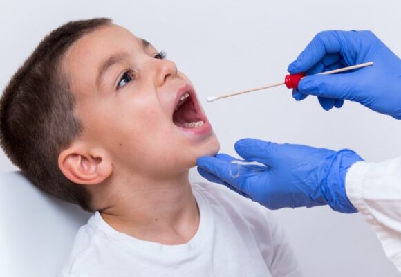 Boy getting throat swab