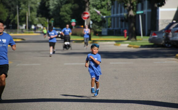 child running on the road in a race