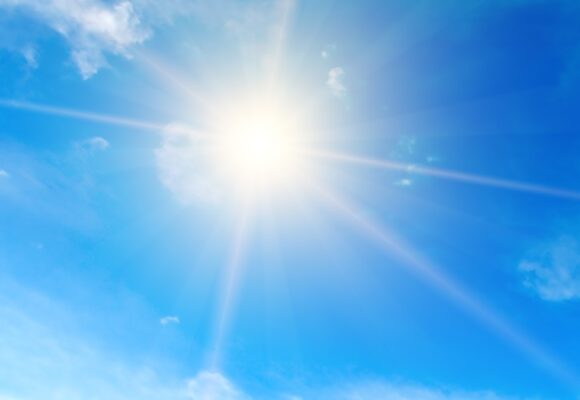 bright shining sun in blue sky