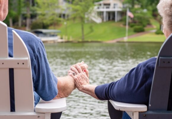 elderly couple holding hands