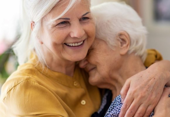 woman hugging an elderly woman