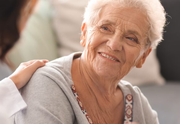Web Older Smiling Woman Listening Woman 580x400