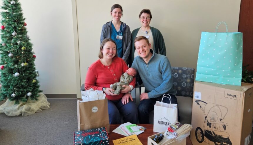 New baby of the year is pictured with her parents, doctor, and nurse