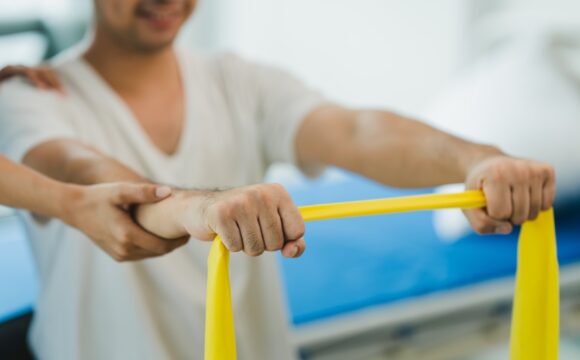 Patient doing exercises with an elastic exercise band with occupational therapist