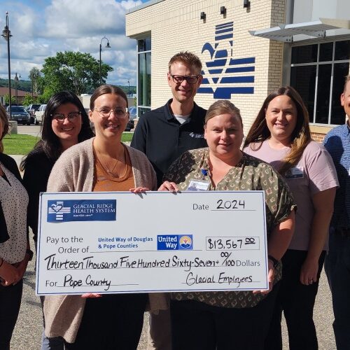 Group of employees with large check for United Way