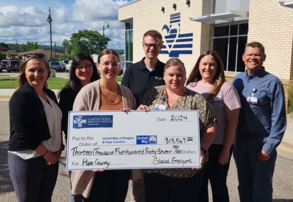 Group of employees with large check for United Way