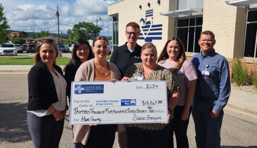 Group of employees with large check for United Way