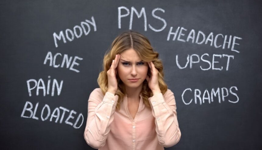 perplexed woman with hands on sides of her head and words on blackboard