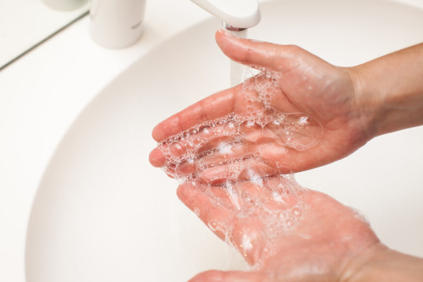 close up photo of woman washes her hands with soap and water