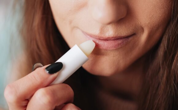 Close Up Woman Applying white Lip Balm