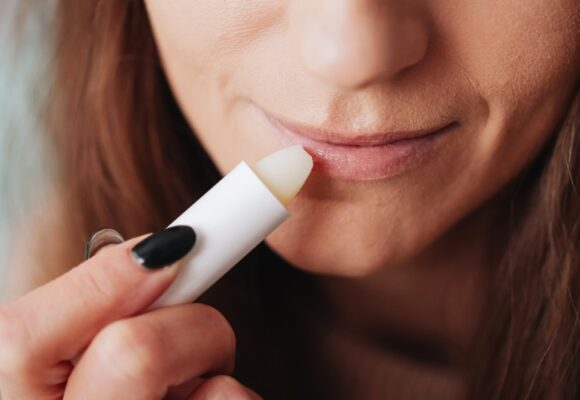 Close Up Woman Applying white Lip Balm