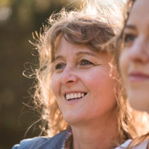 Close up shot of smiling women Close up shot of 2 women