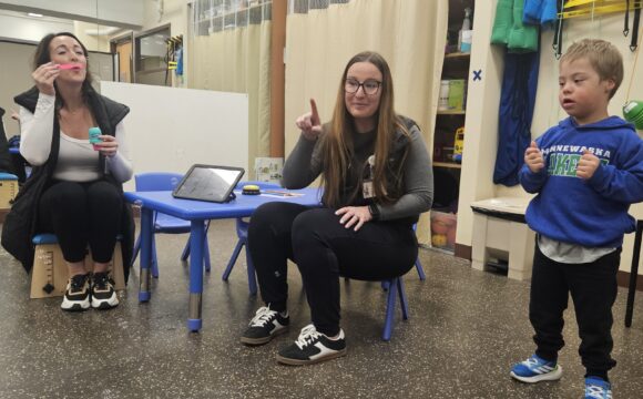 Brianna Hennen playing speech therapy bubbles with child