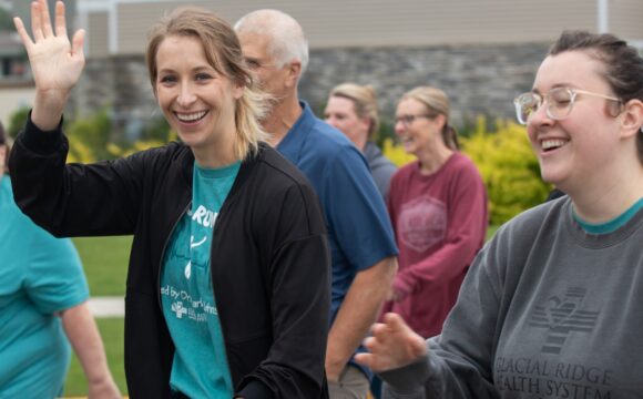 group of walkers at the 5K woman waving to the camera