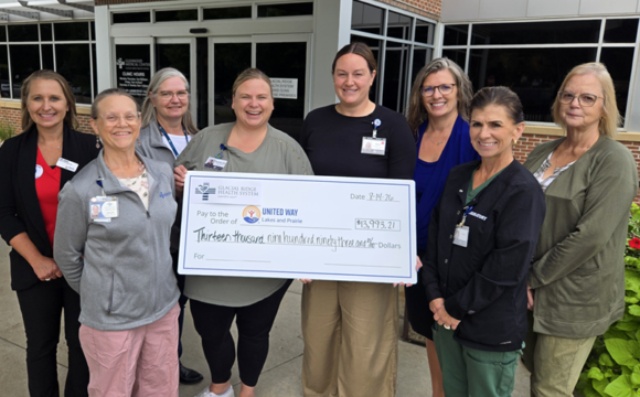 Employees Donate United Way 2026 women and a check