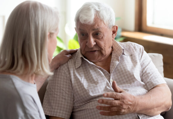 Older man talking to someone who cares Older man talking to a woman