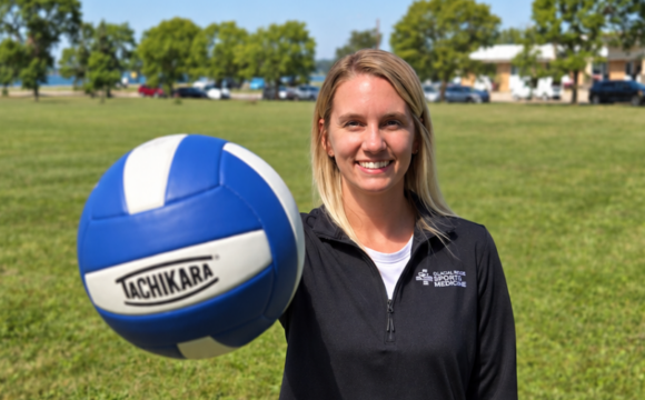 woman palming volleyball woman holding volleyball
